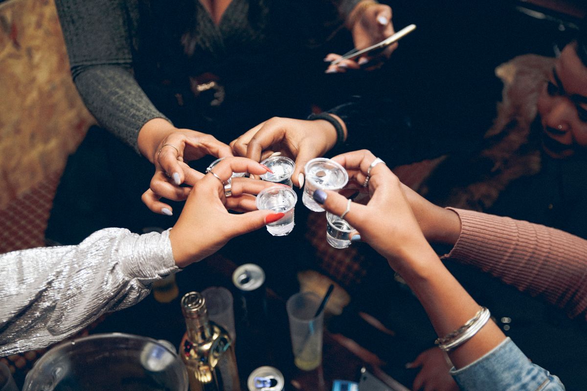 Friends raising shot glasses for a toast