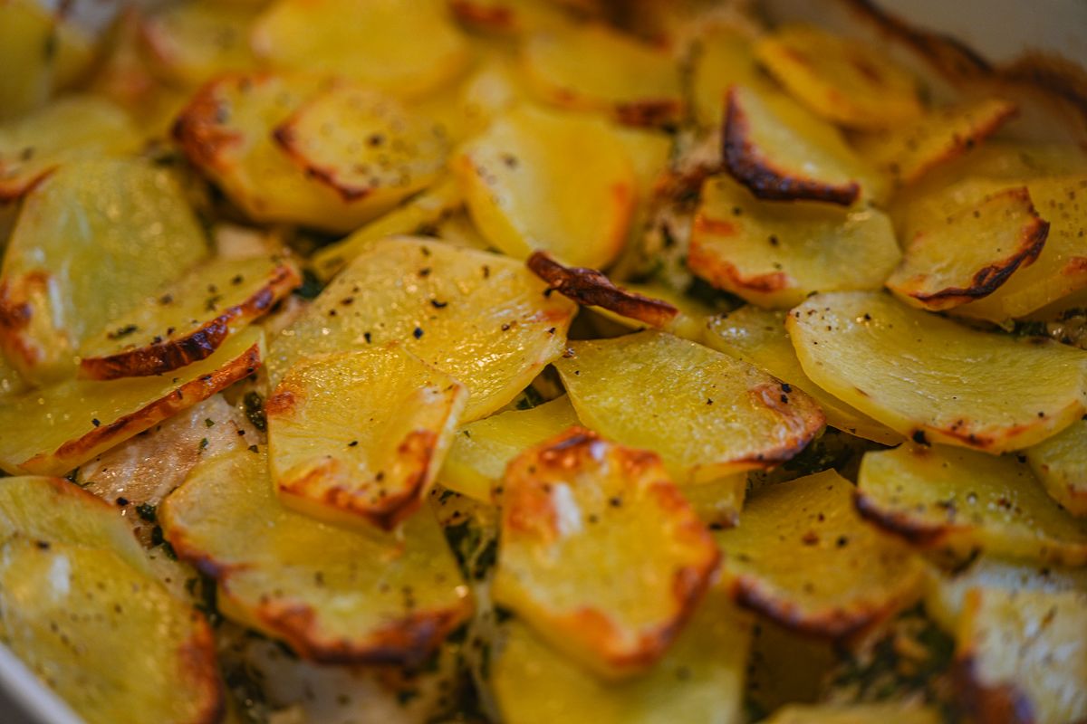 Golden roasted potato slices seasoned with herbs
