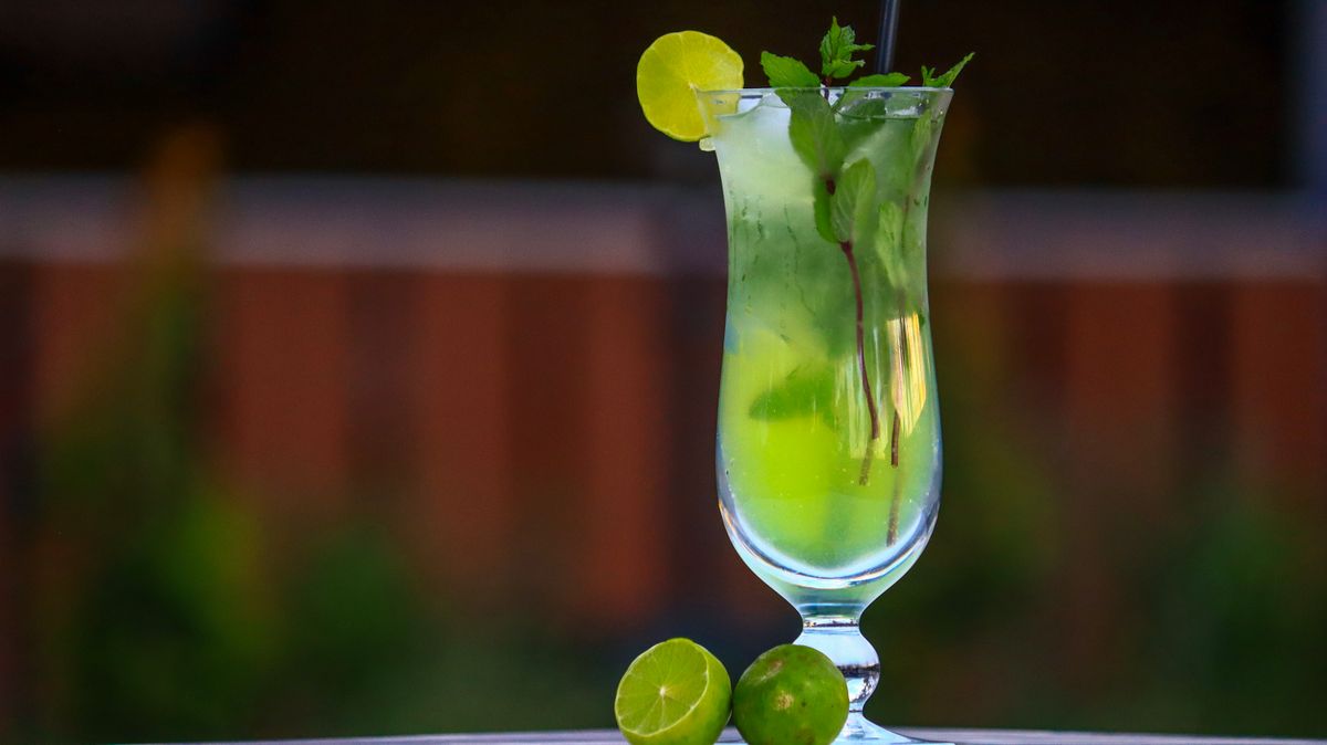 Mojito cocktail garnished with lime and mint