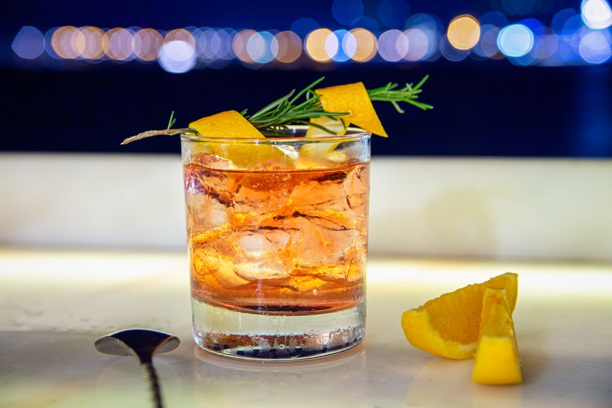 Whiskey cocktail with citrus garnish and ice